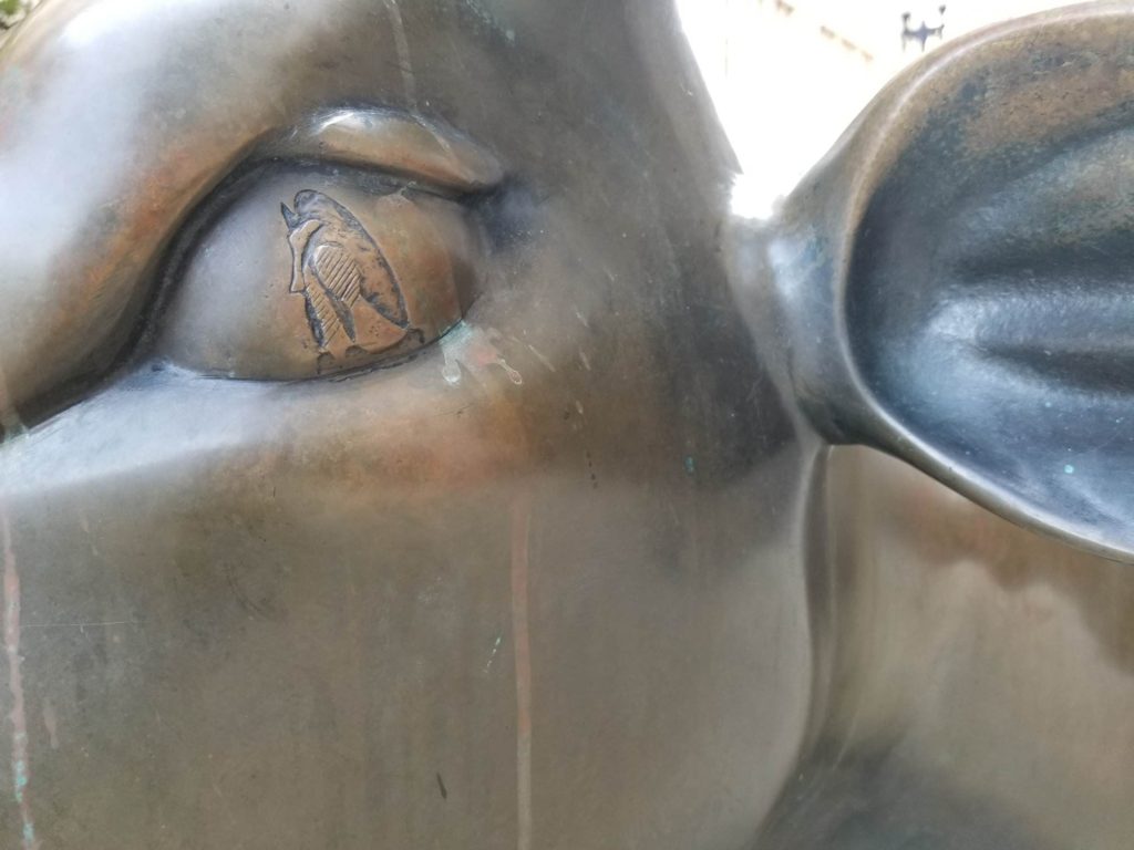 An etching of a Picasso artwork in the eye of a cow sculpture evokes the travel tip “slow down and focus” on surprising little details in Chicago, (Image © Neil Tobin)