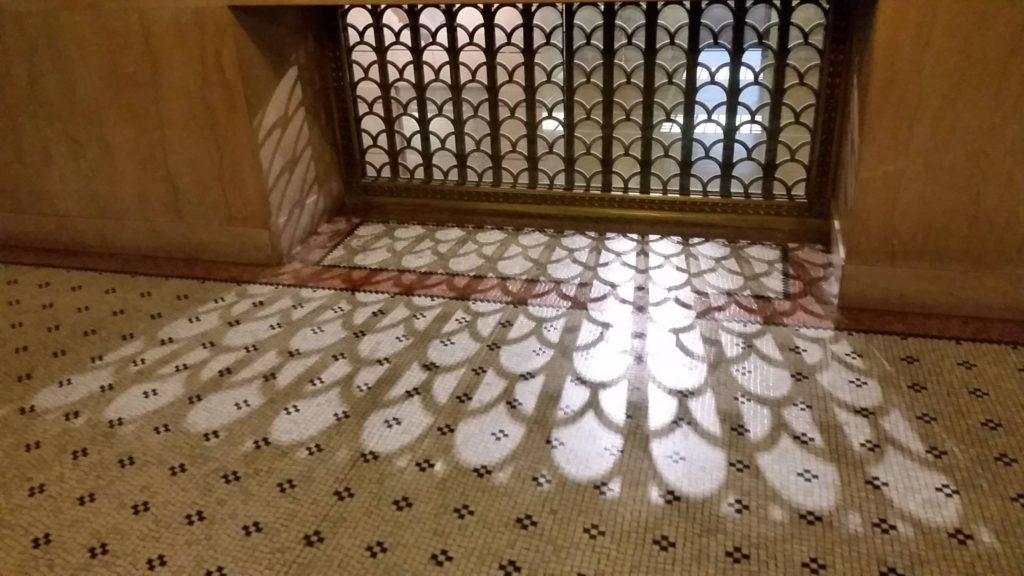 Shadows cast by ornamental ironwork links small details to the history of America’s third biggest city at the Chicago Cultural Center. (Image © by Neil Tobin)