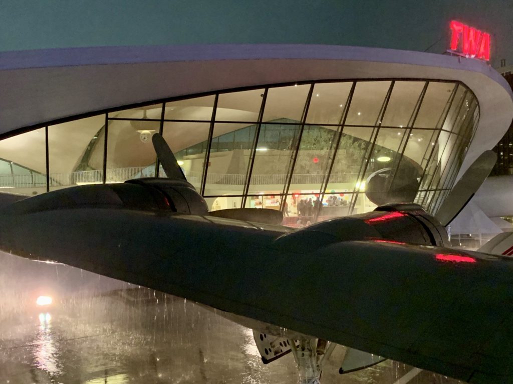 The TWA Hotel at JFK New York on a stormy night seen from the Constellation, or “Connie,” evokes travel memories of Trans World Airlines. (Image © Joyce McGreevy)
