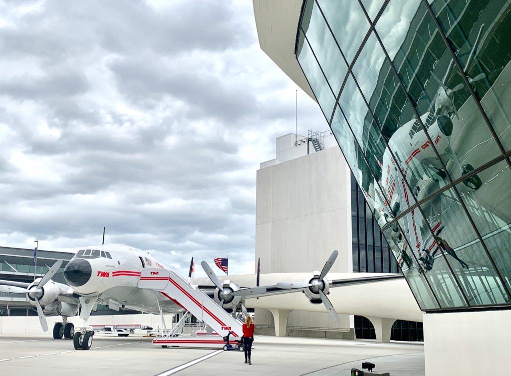 A Trans World Airlines Constellation, or “Connie,” airplane parked outside the TWA Hotel, JFK Airport NY, evokes travel memories at the TWA Reunion. (Image © Joyce McGreevy)