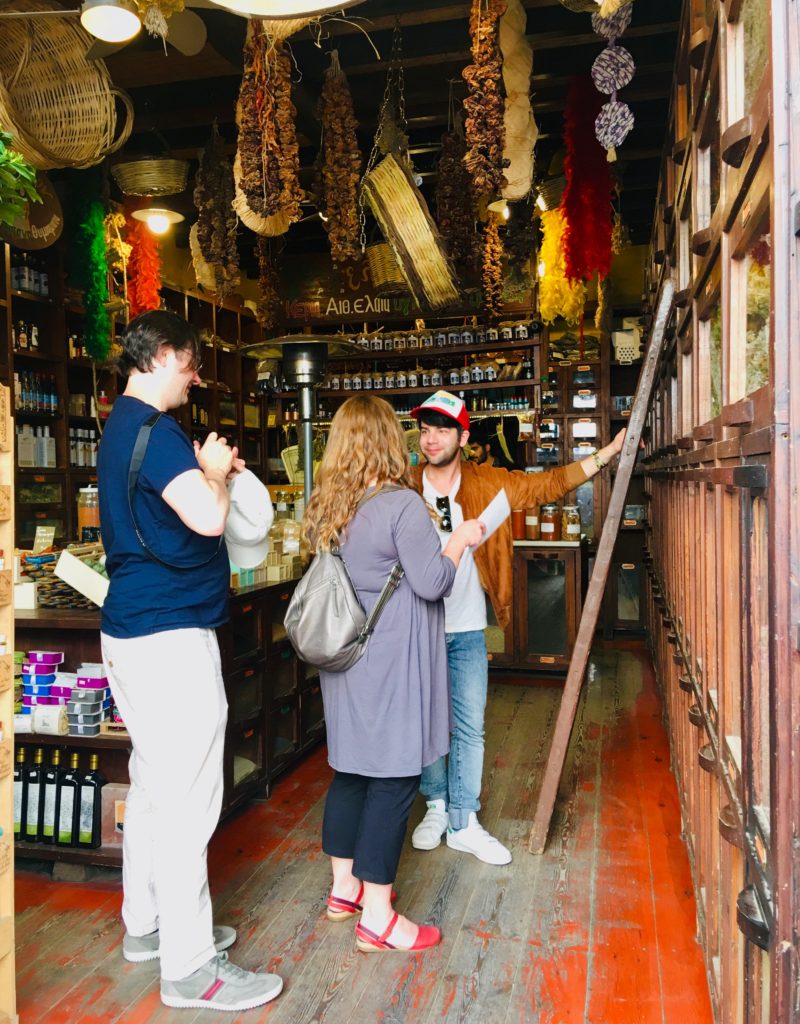 A tour guide with travelers in Athens, Greece provides the cultural context that elevates travel into a life-changing experience. Image © Joyce McGreevy