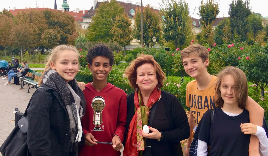 When four teenagers and a writer, Joyce McGreevy, meet in the Volksgarten, Vienna, Austria, they share the fun of speaking two languages. Image © Joyce McGreevy 