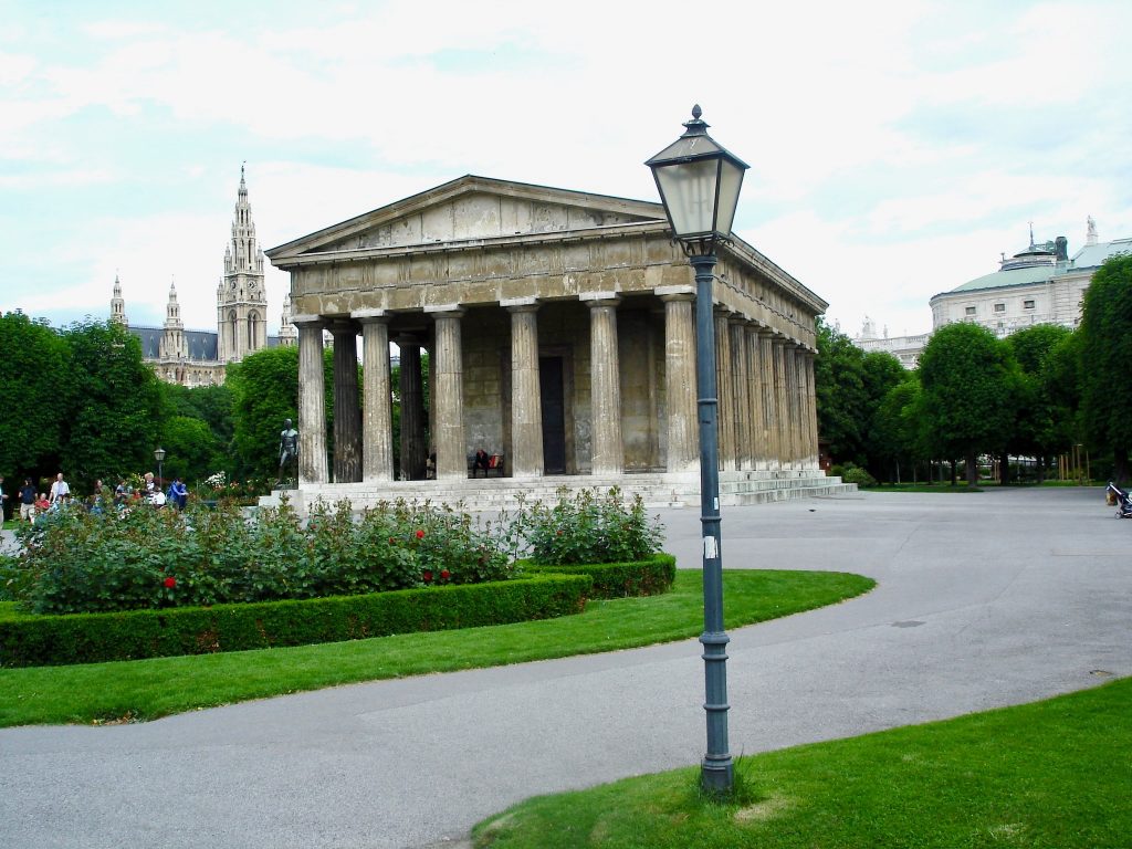 The replica Temple of Theseus at the Volksgarten, Vienna gives a group of visitors an opportunity for speaking in two languages. (Public domain image by Norman Davies) 
