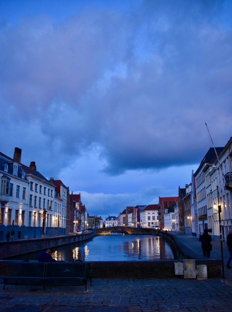 Bruges by night inspires the writer in Belgium, where being bilingual is just the beginning. (Image © Joyce McGreevy)
