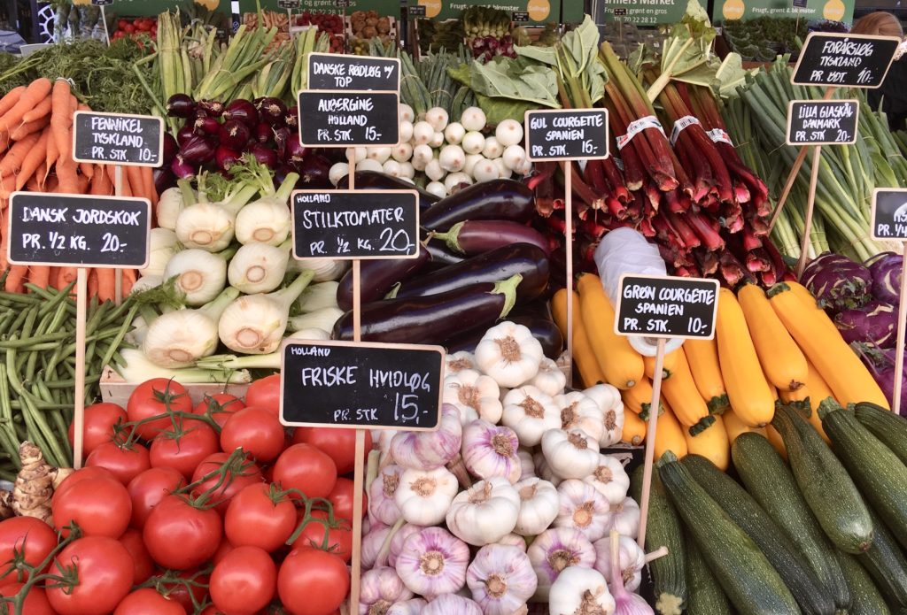 Produce at Copenhagen’s Torvehallerne market includes alliums like onions, a culture crossing staple of global cuisine. (Image © Joyce McGreevy)