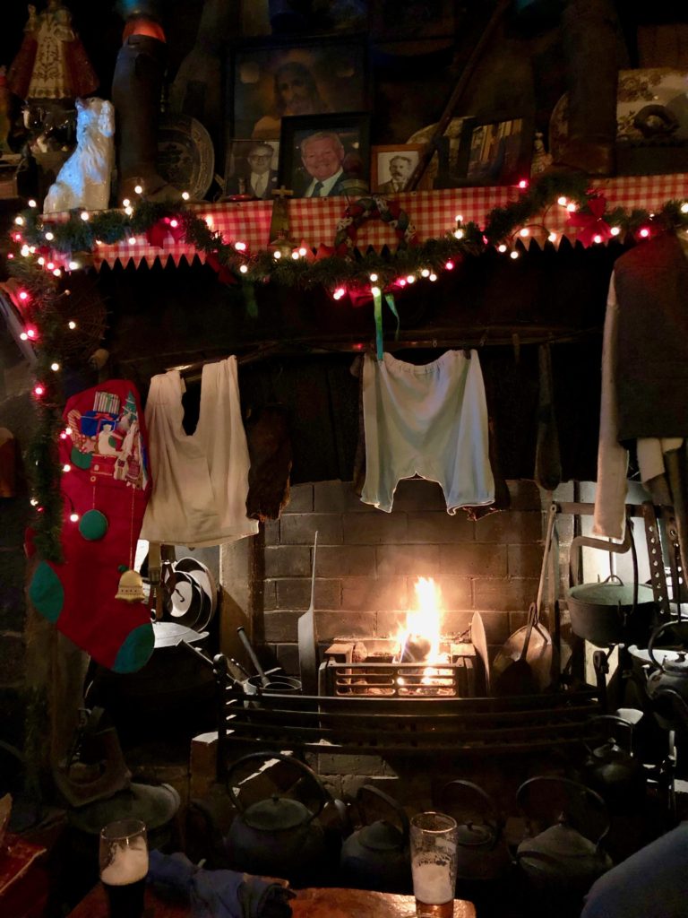 The fireside at O’Connor’s Famous Pub  in Galway reflects the humor and hospitality that inspire holiday travel to Ireland. (Image © Joyce McGreevy)