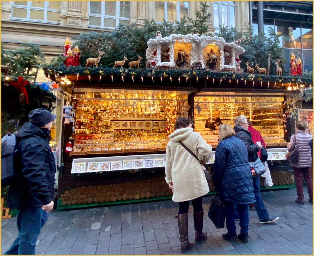 A beautifully decorated vendor’s stall filled with artisan crafts invites shoppers to take a closer look at the Leipziger Weihnachtsmarkt, one of Germany’s Christmas oldest Christmas markets. (Image © Joyce McGreevy)