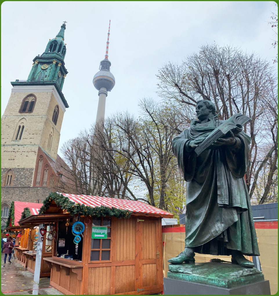 A statue of Martin Luther at a Christmas market in Berlin, Germany reminds the viewer of the church reformer’s role in shaping German Christmas traditions. (Image © Joyce McGreevy)