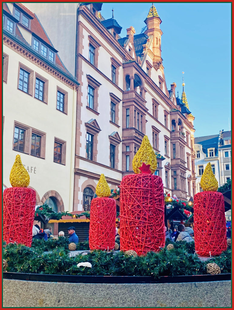 An Advent wreath set against the beautiful architecture of Leipzig, Germany reflects a German Christmas tradition and inspires wanderlust for holiday travel. Image © Joyce McGreevy)