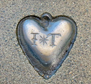 A heart shaped silver token on a London Street is an historical marker and a symbol of the parent-child bond. (Image © Joyce McGreevy)