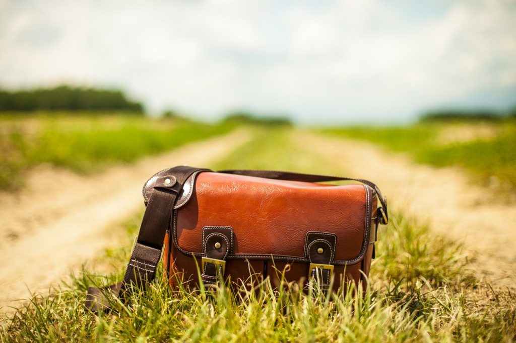 A purse left behind on a dirt road exemplifies the travel mishaps that trigger 20/20 hindsight yet also inspire travel hacks. (Public domain image by Needpix)