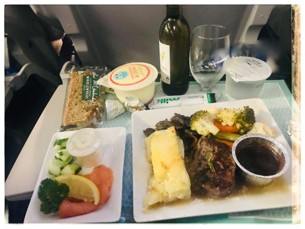 An airline meal accompanies budget travel tips for First-Class Economy travel . (Image © Joyce McGreevy) 