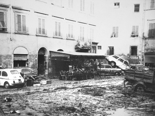 In Florence, a flooded piazza in 1966 is a reminder of threats to Italy's artistic heritage. [image in the public domain]