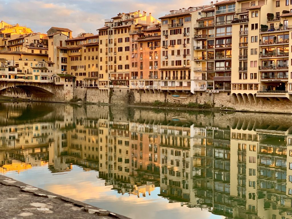 In Florence, reflections of buildings in the Arno river that flooded in 1966 and threatened Italy's artistic heritage. (Image © by Joyce McGreevy)