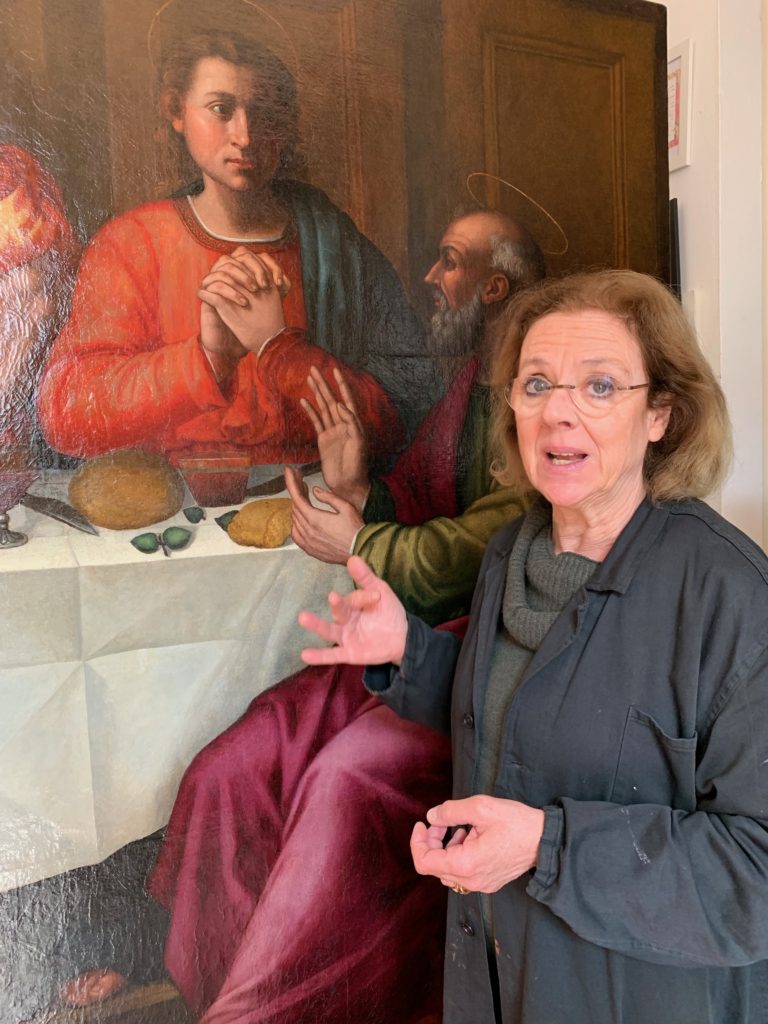Rosella Lari stands before Plautilla Nelli's The Last Supper, which she is restoring as part of Advancing Women Artists' efforts to illuminate the hidden half of Italy's artistic heritage. (Image © by Joyce McGreevy)