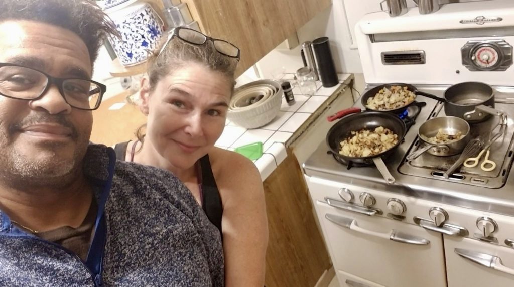 A couple preparing for Seder in their kitchen to share with friends online keep a cultural tradition during the pandemic lockdown. (Image © Jamison and Wendy Clifford Reeves)