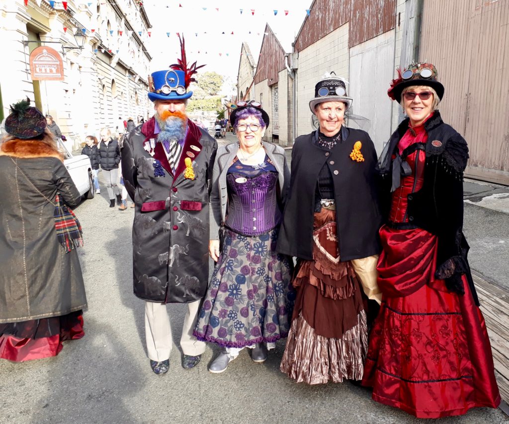 A group of costumed steampunkers enjoy Steampunk Festival NZ, which celebrates the Victorian cultural heritage and creative thinking of Oamaru, New Zealand. (Image © Janet Doyle)