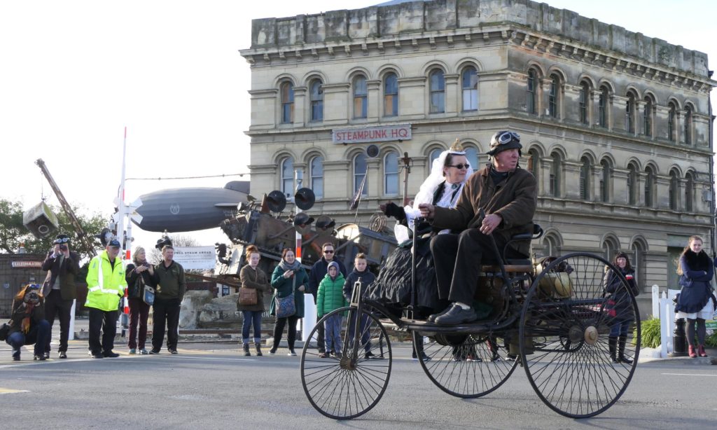 Parade goers cheer the arrival of Queen Victoria (Pinky Agnew) at Steampunk Festival NZ, which reflects the Victorian cultural heritage and creative thinking of Oamaru, New Zealand. (Image © Liz Cadogan) 