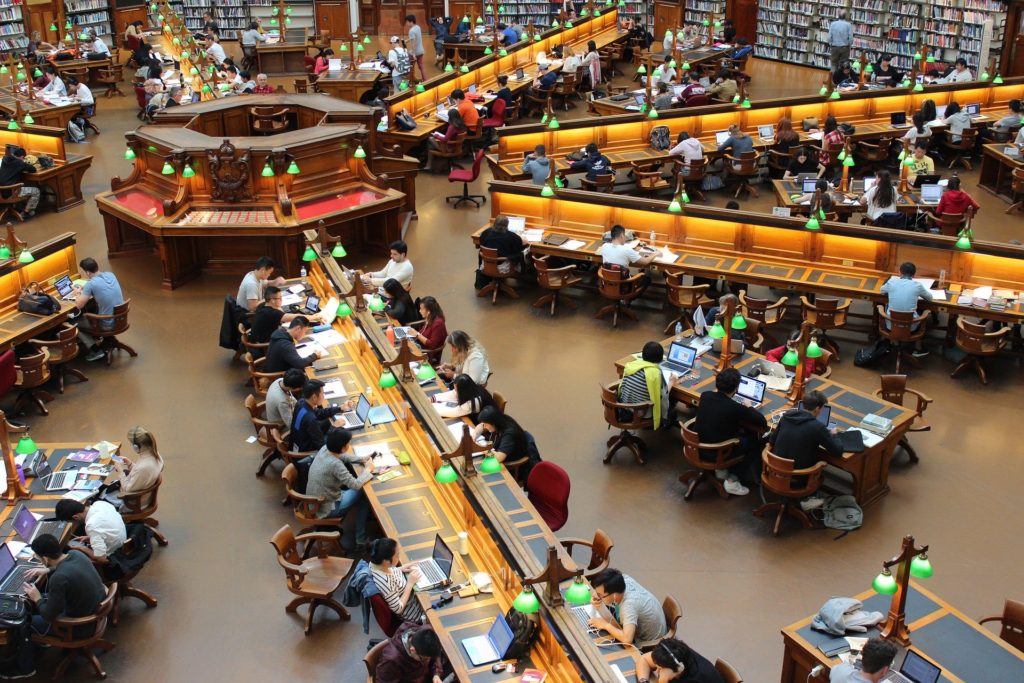 Students in a library before the pandemic remind the author that in 2020 remote learners can still make math connections across cultures. (Image by Andrew Tan)