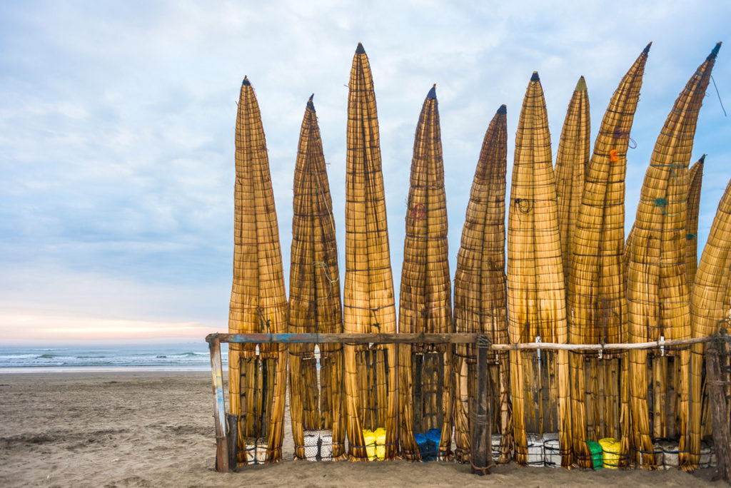 Reed boats, linked to Chiclayo’s fishing and culinary traditions, evoke Peruvian cuisine and culture. (image © xeni4ka/ iStock)