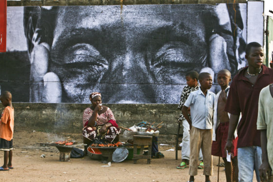 Women Are Heroes photo by artivist JR in Sierra Leone, showing social awareness and answering the question can art change the world. (Image © JR.)