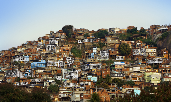 Women are Heroes photos by artivist JR pasted on houses in the Favela Morro da Providência, Brazil, showing social awareness and answering the question can art change the world. (Image © JR.)