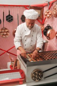 A chef making dozens of tiny pancakes suggests the popularity and variety of easy pancakes from around the world. (Image by mel_88 and Pxhere)