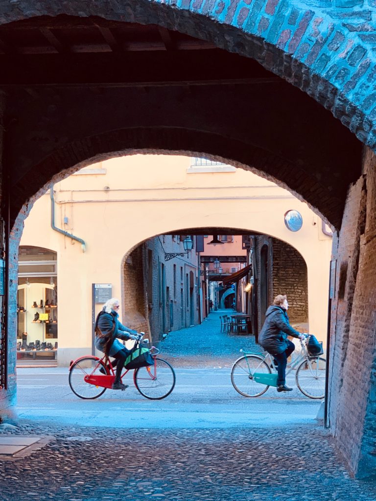 Two bicyclists in Ferrara, Italy call to mind the wordplay of an Italian idiom with ‘bicletta.’ (Image © Joyce McGreevy)