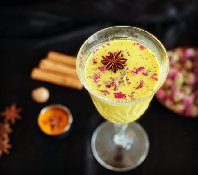 A turmeric latte garnished with star anise and edible flowers show why cooking with spices based on Indian tradition involves more than just adding a dash of powder. (Image © by Nistha Trehun, The Kitty Party)