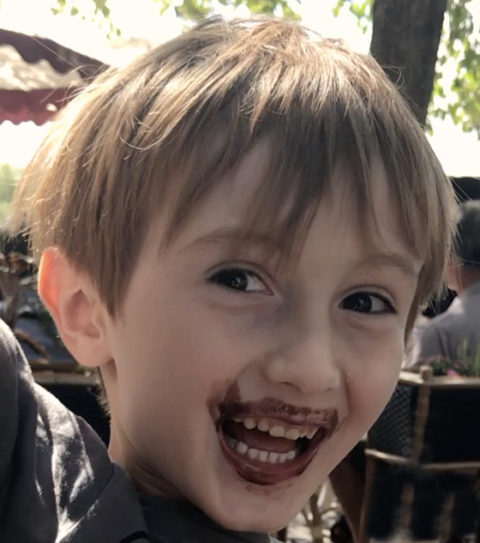 Boy with a chocolate mouth, showing the cultural traditions of chocolate on National Chocolate-Covered Anything Day. (Image © Meredith Mullins.)