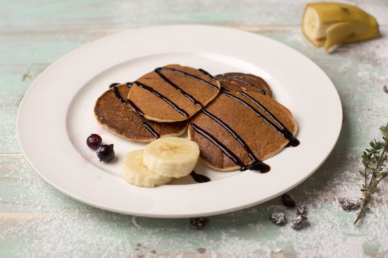Pancakes with chocolate sauce, showing cultural traditions of chocolate for National Chocolate-Covered Anything Day. (Image by PxHere.)