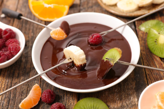 chocolate fondue and fruit, showing cultural traditions of National Chocolate-covered Anything Day. (Photo © iStock/margoullatphotos.)