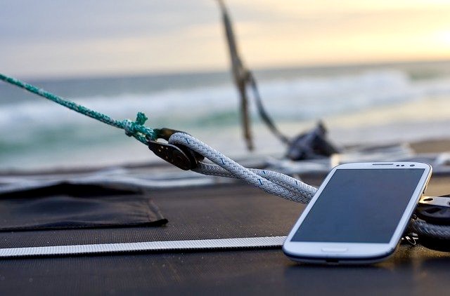A smartphone on a sailboat contains a compass app, a skeuomorph that carries a cultural memory of an ancient invention, the nautical compass. (Photo by TheHilaryClark and Pixabay)