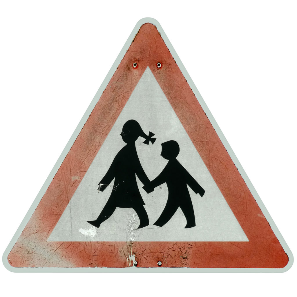 This triangular school zone sign from Germany shows a girl confidently leading a boy to school and is part of a series of school zone signs from different cultures. Image © prill/iStock.