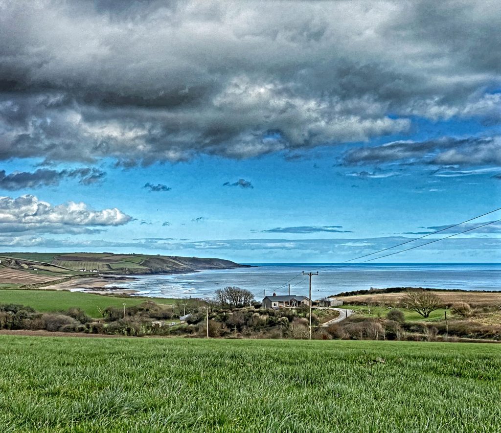 Rain clouds over Ballyshane, County Cork, Ireland, foreshadow a time when social distancing and self-isolation will become the norm, and virtual travelers will go online to stay connected across the miles. (Image © by Joyce McGreevy)