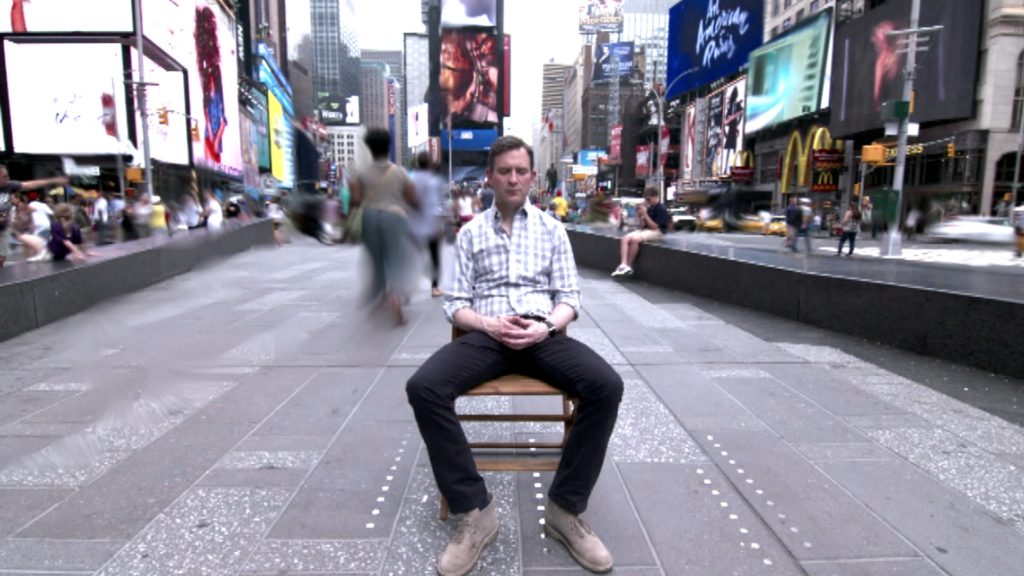 Dan Harris, meditating in Times Square, offers cross-cultural tips for staying calm through the app Ten Percent Happier. (Image © Samuel Johns/ 10% Happier)