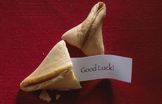 A broken fortune cookie with a message of "Good luck!" to illustrate wordplay all around the world. (Image © Brand X Pictures/Stockbyte)