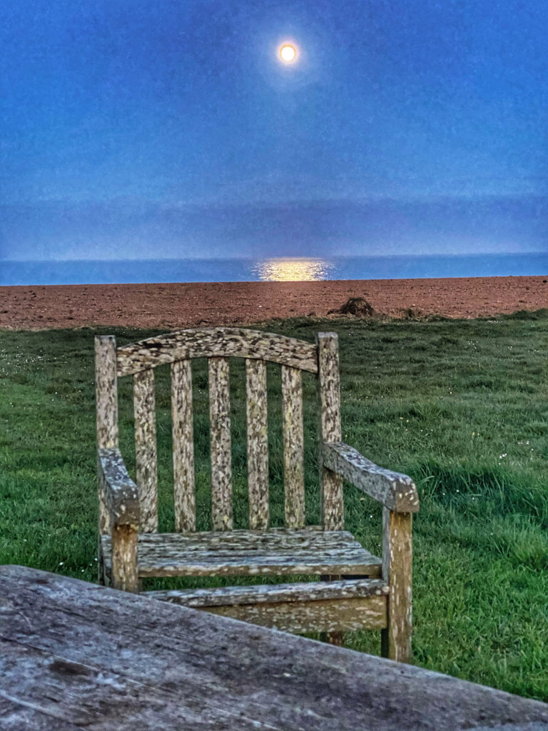 A chair outdoors under the moon on the Irish coast is an invitation to notice and connect with the awe-inspiring beauty of nature, which in turn can influence our cultural attitude toward the environment, (Image © Joyce McGreevy)