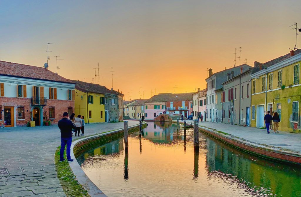Evening in Comacchio, Emilia Romagna, awakens wanderlust for Italy and is a place recommended for visit in the author's travel planning tips for Italy. (Image © Joyce McGreevy)
