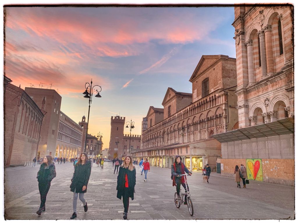 People walking in Piazza Trento e Trieste, Ferrara, Italy, a vibrant place recommended for a visit in the author's travel planning tips for Italy. (Image © Joyce McGreevy) 