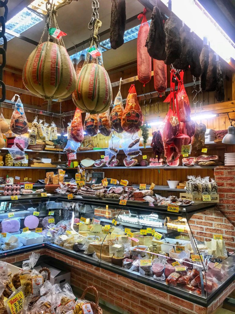 A food market stall in Bologna inspires wanderlust for Italy and is part of the author's travel planning tips for Italy. (Image © by Carolyn McGreevy)